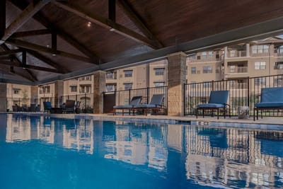 Indoor swimming pool area with lounge chairs