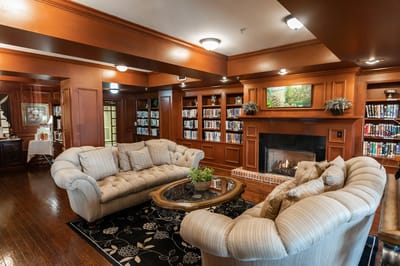 Cozy common area with bookshelves and seating.