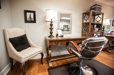 Hair salon area with chair and mirror