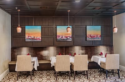 Elegant dining area with decorated tables and artwork