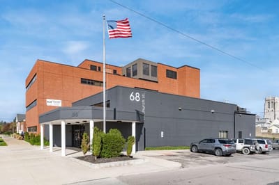 Exterior view of a facility building with American flag