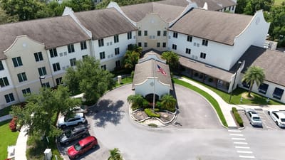 Aerial view of the facility entrance with landscaping and vehicles