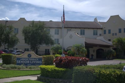 Exterior view of Arbor Terrace Senior Living with landscaping