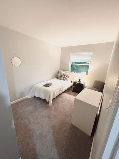 Cozy resident room with a bed and bedside table