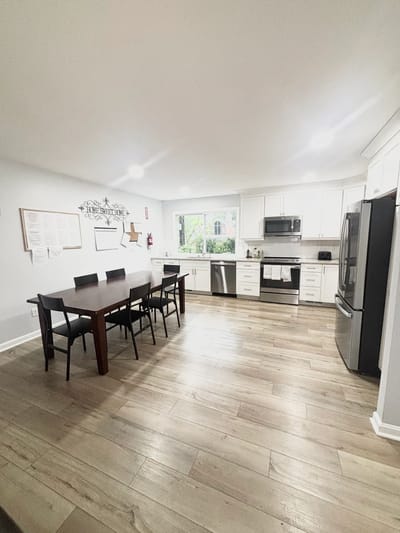 Bright kitchen with dining table and modern appliances
