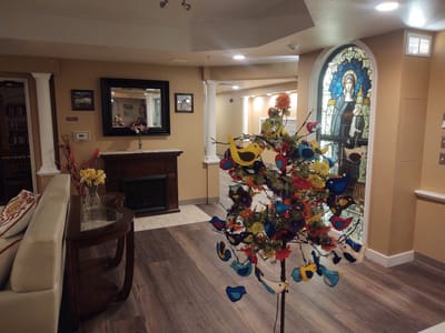 Interior common area with decorative tree and artwork