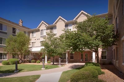 Exterior view of the Clare of Assisi facility with landscaping