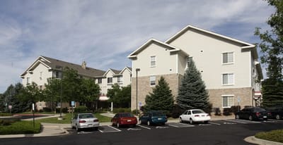 Exterior view of a senior living facility with parking