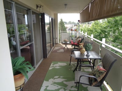 Balcony with seating and greenery overlooking the outdoors
