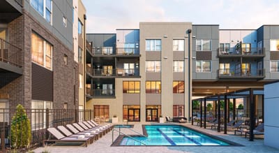 Exterior view of a modern assisted living facility with a pool