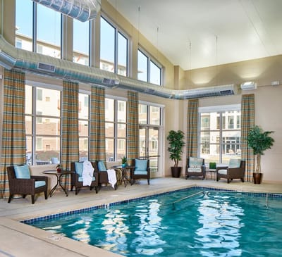 Indoor swimming pool area with seating