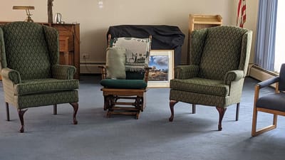 Cozy seating area with patterned chairs and a recliner
