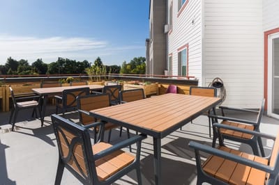 Outdoor patio area with tables and chairs.