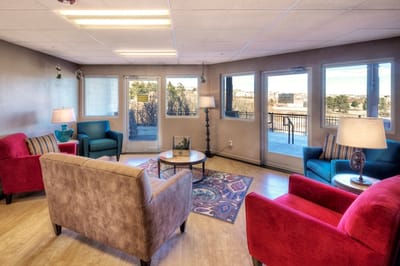 Bright common area with seating and large windows