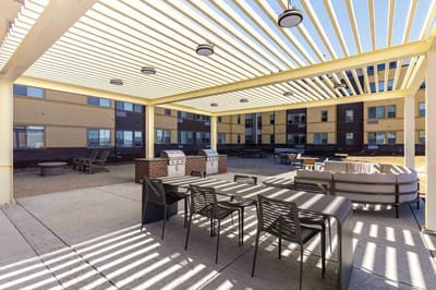 Outdoor patio area with seating and grills