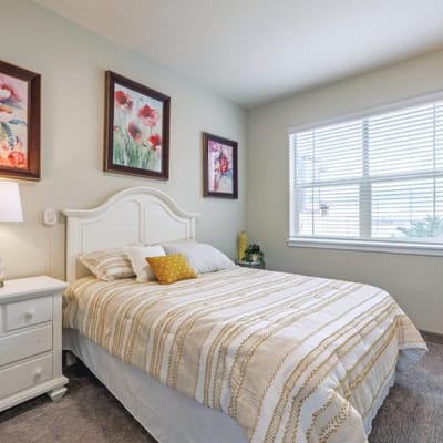 Cozy bedroom with floral artwork and a window