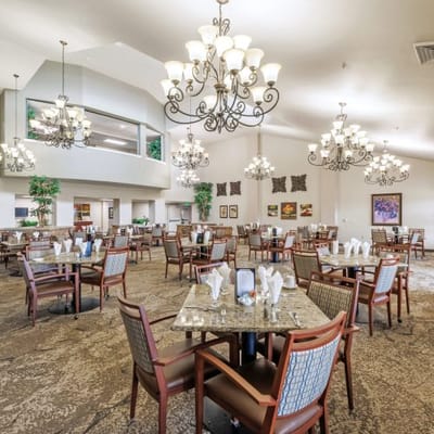 Dining room setup with elegant chandeliers and tables