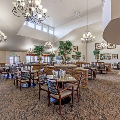 Bright dining room with spacious seating and chandeliers