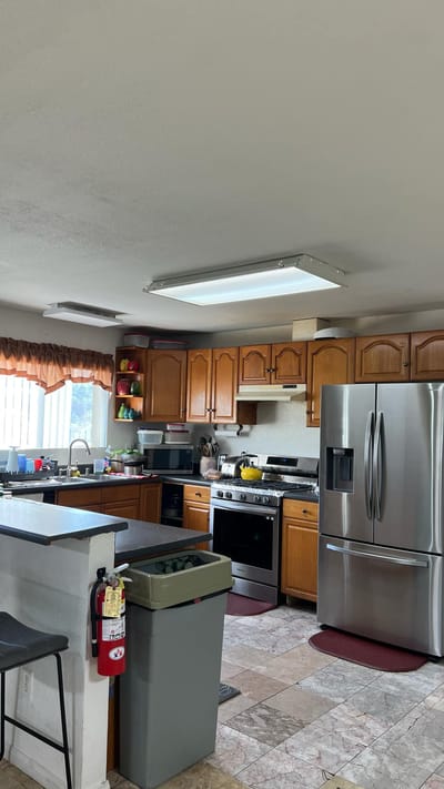 Interior kitchen space with wooden cabinets and appliances