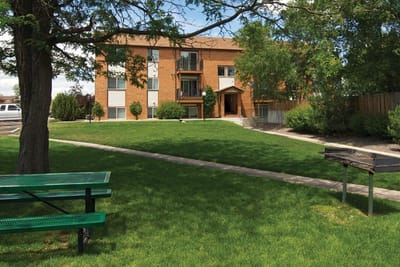 Exterior view of Pinecrest Apartments with green space