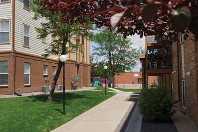 Pathway through landscaped outdoor space with play area