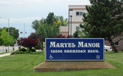 Sign for Maryel Manor Apartments on a sunny day
