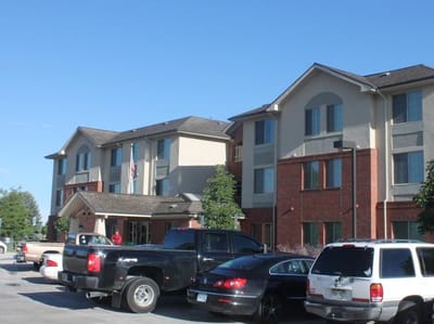 Exterior view of the facility building with parking area