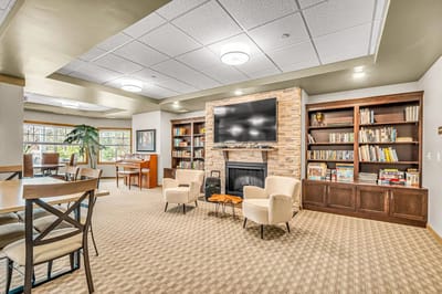 Common area with seating, bookshelves, and a fireplace