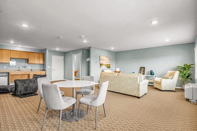 Bright common area with seating and a dining table