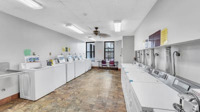 Laundry room with washing machines and dryers