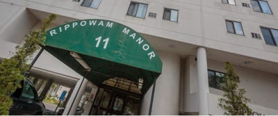 Entrance of Rippowam Manor with awning and signage