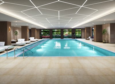 Indoor swimming pool area with lounge chairs