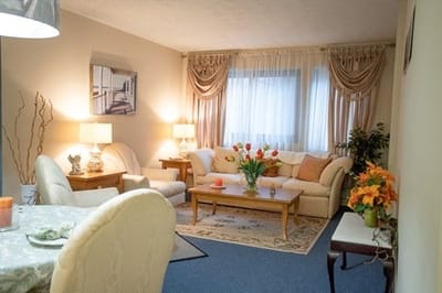 Cozy living room setting with comfortable furniture and flowers