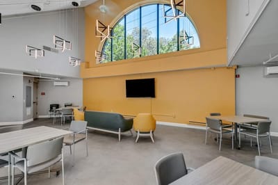 Common area with modern furniture and large windows