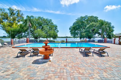 Outdoor swimming pool with lounge chairs and fountain