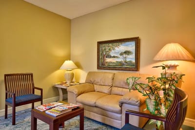 Cozy seating area with a couch and lamps.