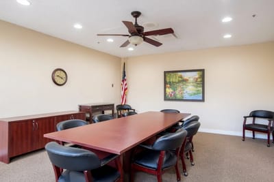 Meeting room with table, chairs, and artwork