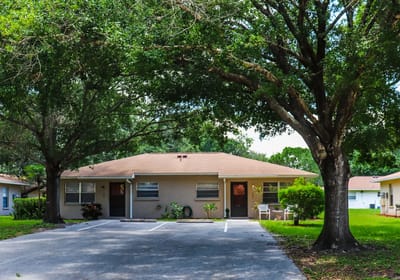 Exterior view of a residential building surrounded by trees.