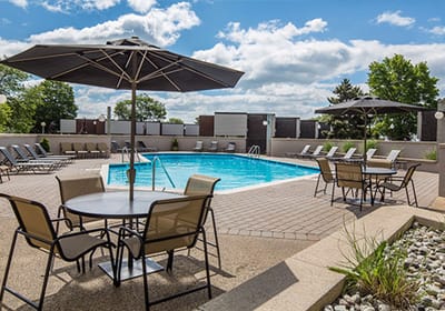 Outdoor pool area with seating and umbrellas