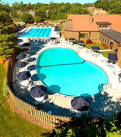 Aerial view of an outdoor pool and patio area.