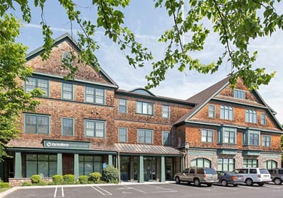 Exterior view of a senior living facility with parking.