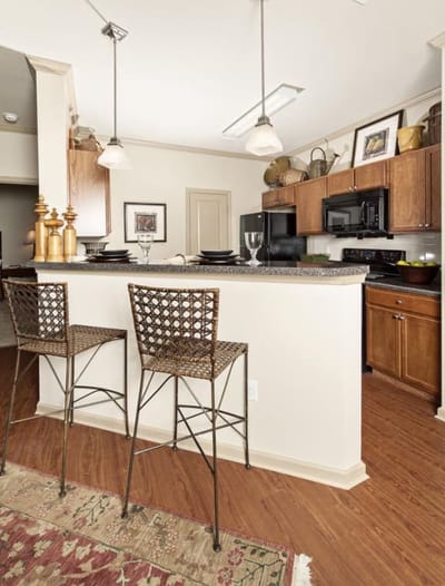 Modern kitchen with bar stools and amenities