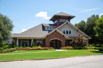 Exterior view of the facility building surrounded by flowers.