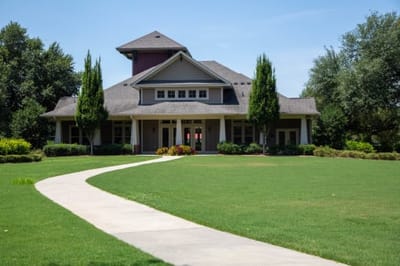 Exterior view of the facility with landscaping and path
