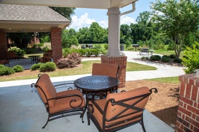 Seating area in outdoor space with garden views.