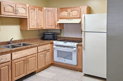 Bright kitchen with wooden cabinets and appliances