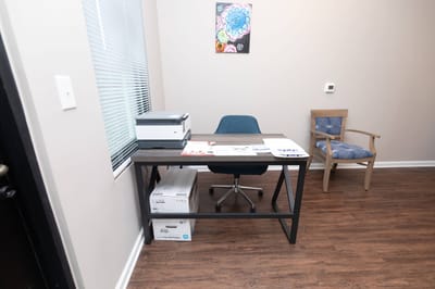 Desk and chair in a well-lit room.