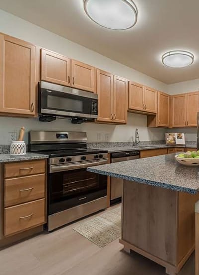 Modern kitchen with wooden cabinets and stainless steel appliances