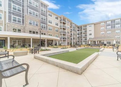 Outdoor seating area with landscaped grounds.