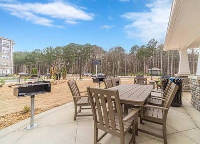 Outdoor seating area with tables and grill